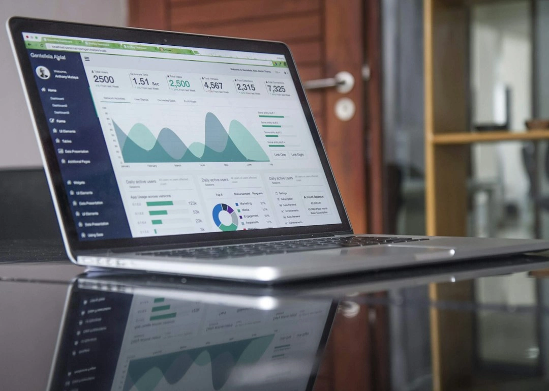 Laptop displaying market analytics on a desk